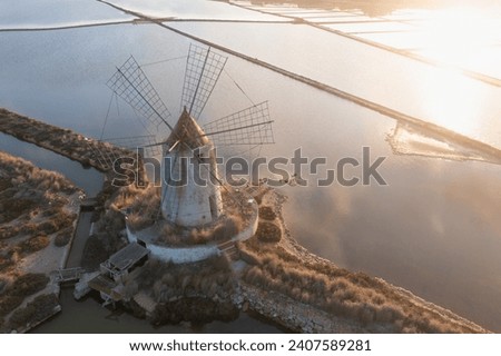 Sunset at Windmills in the salt evoporation pond in Marsala, Sicily island, Italy
Trapani salt flats and old windmill in Sicily.
View in beautifull sunny day.