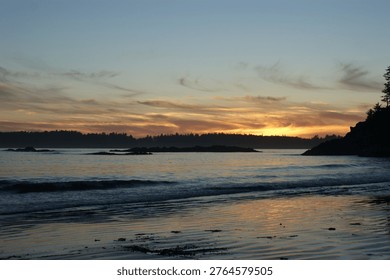 Sunset With Wispy Clouds Over Ocean Cove And Rolling Hills