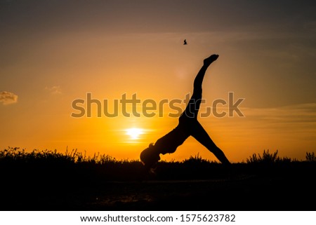 Similar – Two sisters doing gymnastics at sunset