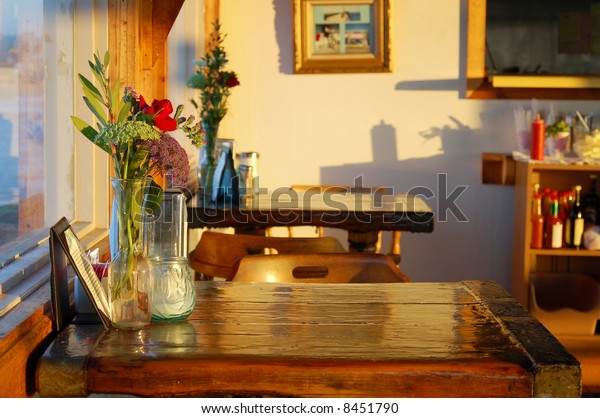 Sunsetlit Table Floral Decoration Small Cafe Royalty Free
