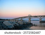 Sunsets falls as a full moon rises behind the Coleman Bridge in Yorktown, VA