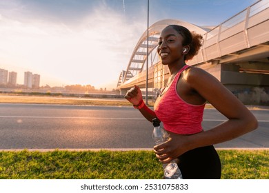 In sunset's glow, the African American woman runs the promenade with grace.  - Powered by Shutterstock