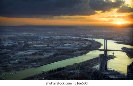 Sunsetting over a city, with a bridge featuring