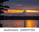 Sunsetting through clouds on lake golden hour on remote lake in the Chippewa National Forest, northern Minnesota USA