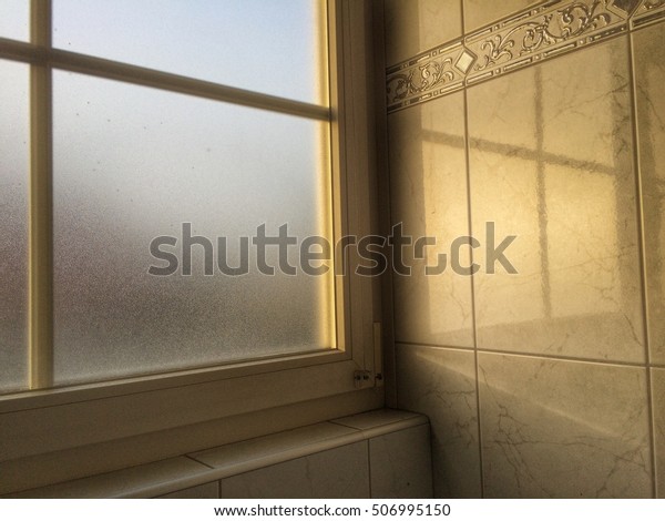 Sunshine in the morning. Light through window Opaque\
glass in the bathroom 