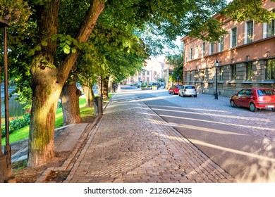Sunshine on the trees, sidewalks and historic buildings of Linnankatu in Turku, Finland.
