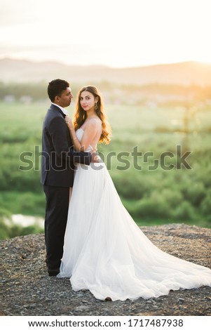 Sunshine portrait of happy bride and groom outdoor in nature location