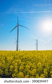 Sunshine, rapeseed and windwheels seen in rural Germany
