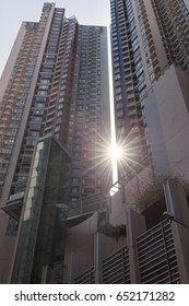 Sunshine and rays through 2 high modern office buildings.