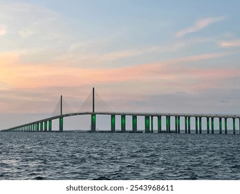 The Sunshine Skyway Bridge, a cable stayed suspension bridge, spans the lower entrance to Tampa Bay at St Petersburg and is in silhouette against the sunset sky