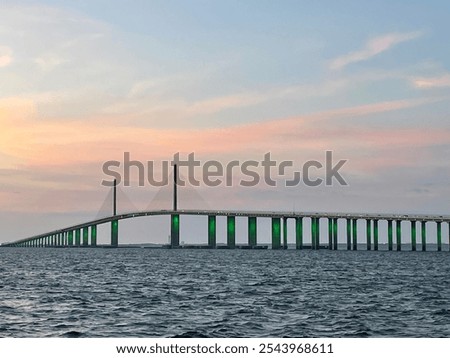 The Sunshine Skyway Bridge, a cable stayed suspension bridge, spans the lower entrance to Tampa Bay at St Petersburg and is in silhouette against the sunset sky