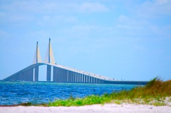 Sunshine Skyway Bridge Crossing Tampa Bay In Florida With A Beach In The Foreground