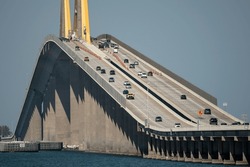 Sunshine Skyway Bridge Over Tampa Bay In Florida With Moving Traffic. Concept Of Transportation Infrastructure