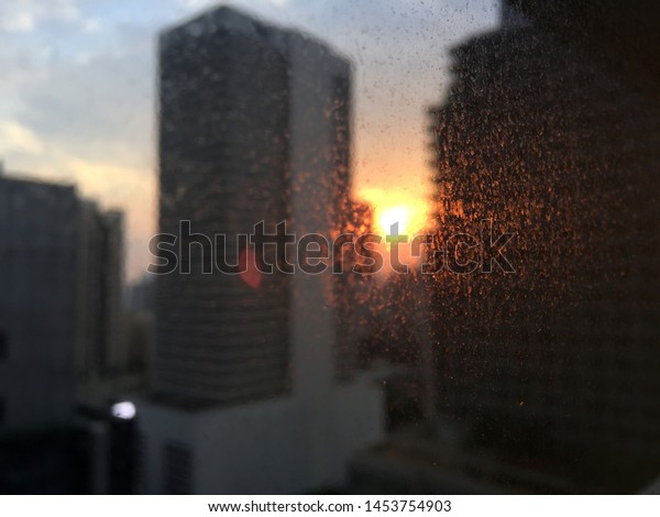 Sunshine\
through dusty windows from a Bangkok\
office