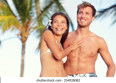 Suntan Fit Body Couple Beach Travel Portrait. Handsome Caucasian Man And Good Looking Asian Woman Fitness Young Adults With Tanned Skin For Weight Loss Concept Or Beach Vacation Holidays.