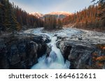 Sunwapta Falls is pair of the Sunwapta river in autumn forest at sunset. Icefields Parkway, Jasper national park, Canada