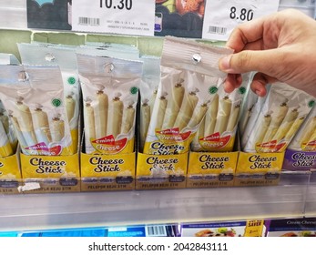 Sunway Piramid, Malaysia - 4 September 2021 : Hand Pick Up A Packed Of EMINA Cheese Stick For Sell On The Supermarket Shelf With Selective Focus.