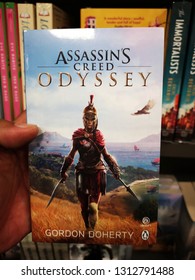 Sunway Piramid, Malaysia - 9 February 2019 : Hand Hold A ASSASSIN'S CREED - ODYSSEY By Gordon Doherty Book For Sell In The Book Stores.