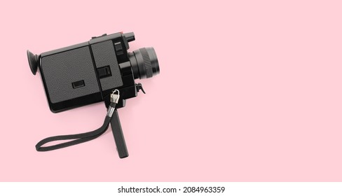 Super 8 Film Camera Isolated On Pink Background. Copy Space