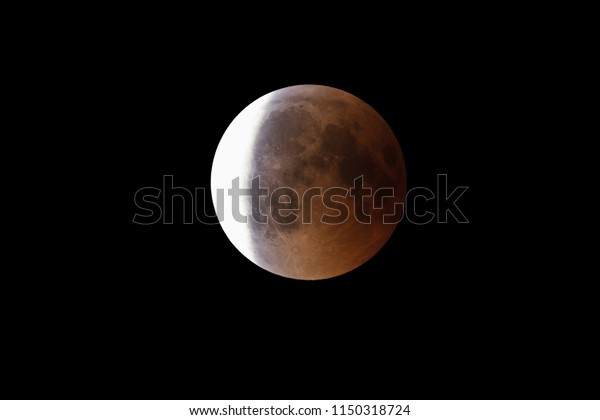 Super Bloody Moon, full eclipse end phase against\
black sky background, three-quarters of the Moon surface covered by\
Earth\'s shadow