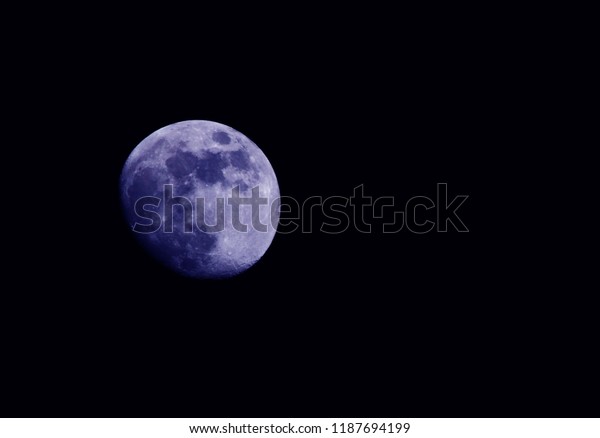 Super blue moon isolated on black\
background - Real moon on dark night sky selective\
focus