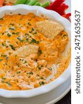 Super Bowl Buffalo Chicken Dip - savory spicy dip made with the classic Frank’s Red Hot Sauce, flavorful rotisserie chicken, rich cream cheese and mayo, melty cheese and a few fresh herbs.