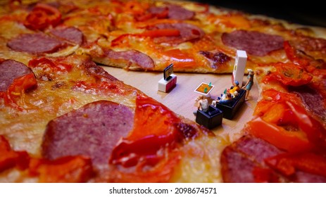 Super Bowl day party. Family watching American football match and eating pizza, conceptual photo with miniature figurines. Snacks and drinks for watching a football game. - Powered by Shutterstock
