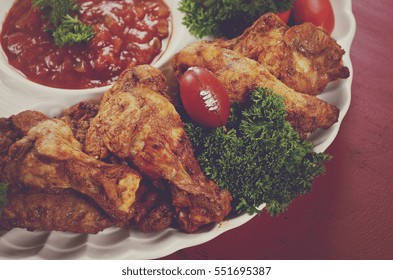 Super Bowl Sunday Football Party Celebration Food Platter With Chicken Buffalo Wings, Meat Balls, Hot Dogs And Salsa Dip On Red Wood Table, With Applied Retro Style Filters.