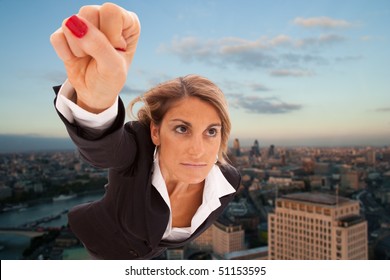 Super businesswoman flying over London city - Powered by Shutterstock