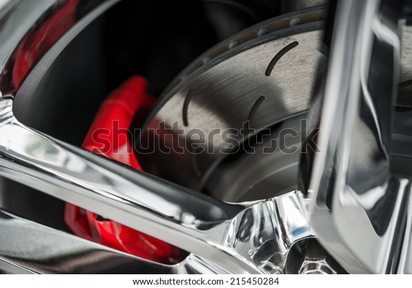 Super Car Brakes. Disc Brake.\
Disc Pads, Wheel Bearing, Caliper Assembly. Car Brakes Closeup\
Photo.