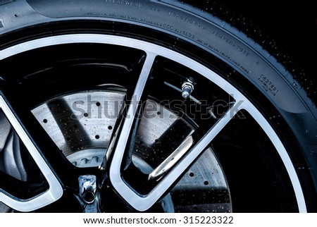 Super car disc brake. Car wheels. steel alloy car disks background template for design work.  car rims isolated on black background. car alloy wheel. Close-up shot of a car's brake disc.