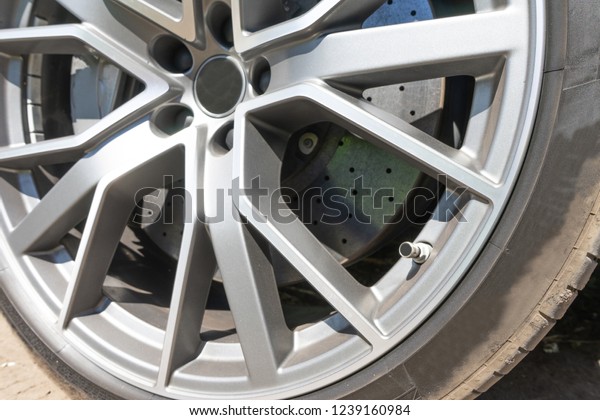 Super car disc brake. Car wheels. steel alloy\
car disks background template for design work. Car alloy wheel.\
Close-up shot of a car\'s brake\
disc.