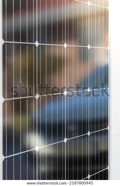 Super\
closeup view of monocrystalline black solar panel with a white car\
reflection on it Renewable solar energy\
concept