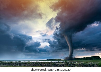 Super Cyclone or Tornado forming destruction over a populated landscape with a home or house on the way. Severe storm weather clouds.