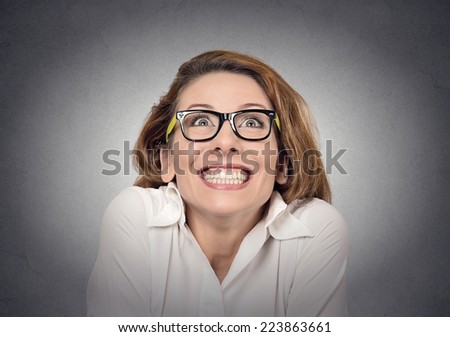 super excited funky girl looking up on grey wall background 