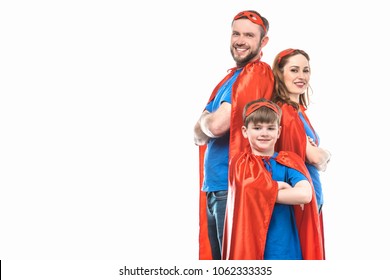 super family in masks and cloaks standing with crossed arms and smiling at camera isolated on white