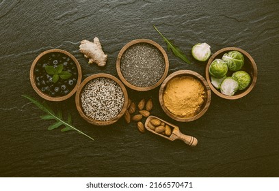 Super Foods On In Wooden Bowl. Selection Food And Healthy Food Set Up On Dark Stone Background.