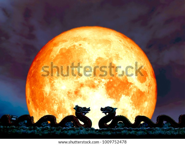 super full blood moon double\
dragen on roof and night sky, Elements of this image furnished by\
NASA