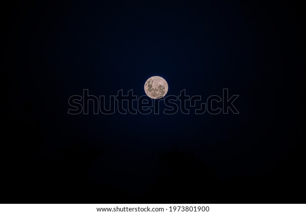 Super\
full moon in the middle of a dark sky\
background