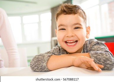 Super Fun. Close Up Shot Of A Cute Little Boy Laughing Hilariously Sitting At A Table Copyspace Happiness Joy Laughter Childhood Carefree Children People Kids Positivity Expressive Emotions Concept