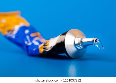 super glue tube on blue background - Shutterstock ID 1161037252