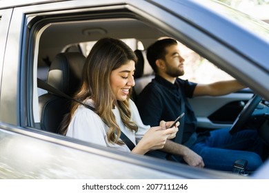 Super Happy Woman Texting On Her Smartphone While On The Passenger Seat. Couple Going Out On A Date In The Car 