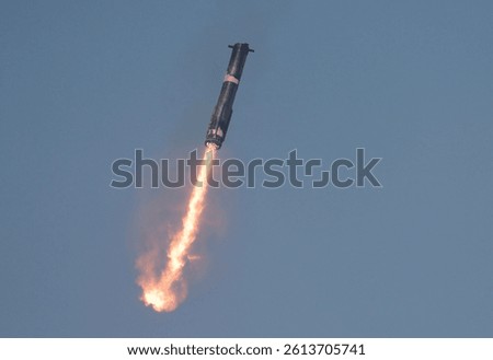 The Super Heavy booster descends back to its launch pad after successfully propelling Starship into space during its eighth test, marking a milestone in spaceflight.