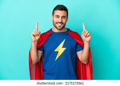 Super Hero Caucasian Man Isolated On Blue Background Pointing Up A Great Idea