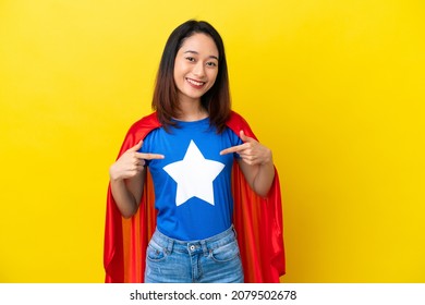 Super hero Vietnamese woman isolated  on yellow background proud and self-satisfied