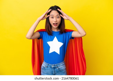 Super hero Vietnamese woman isolated  on yellow background with surprise expression