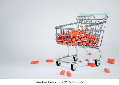 super market cart full of orange pills on white background. copy space. supermarket cart full of orange pills on white background. copy space. concept of pill dependency. - Shutterstock ID 2279305389