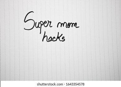 Super Mom Hacks Writing Love Text For Mother On Paper. Label Tag With Lovely Message For Mother`s Day.