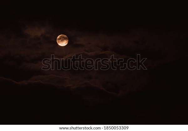 Super moon. An attractive photo of the night sky
background with a cloudy and bright full moon. Night sky with a
beautiful full moon.