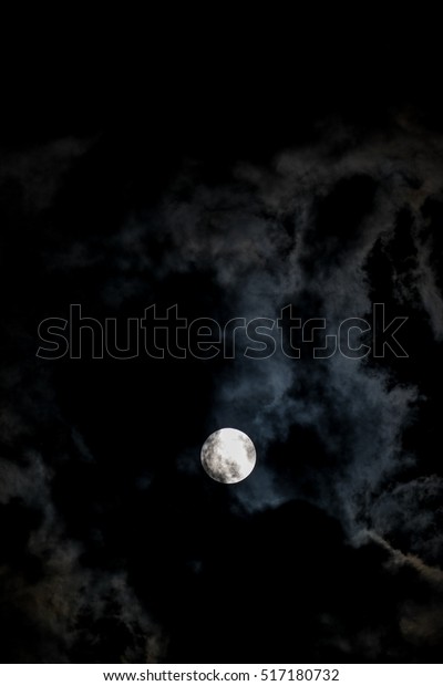 super moon with clouds, Full moon in the night,\
detail of moon during autumn. Night photography. Interesting\
astronomy phenomenon on the night\
sky
